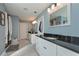 Bright bathroom featuring tile floors, white cabinets with a dark countertop, and a separate shower at 8340 Nolandwood Ln, Villa Rica, GA 30180