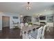 Open dining area with a view to the staircase, living room and modern kitchen at 8340 Nolandwood Ln, Villa Rica, GA 30180