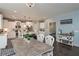 Bright dining area and modern kitchen with white cabinets and stainless steel appliances at 8340 Nolandwood Ln, Villa Rica, GA 30180