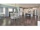 Bright dining area with hardwood floors, white furniture and view of modern kitchen at 8340 Nolandwood Ln, Villa Rica, GA 30180