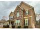 Beautiful home with a combination of stone and siding, complemented by dark shutters and a well-maintained yard at 8340 Nolandwood Ln, Villa Rica, GA 30180