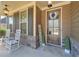 Cozy front porch with rocking chairs, a decorative wreath, and a 'Welcome' sign, creating a warm entrance at 8340 Nolandwood Ln, Villa Rica, GA 30180