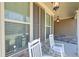 Inviting front porch with rocking chairs and stylish lanterns, perfect for relaxing outdoors at 8340 Nolandwood Ln, Villa Rica, GA 30180