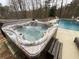 Inviting hot tub adjacent to a sparkling in-ground pool at 8340 Nolandwood Ln, Villa Rica, GA 30180