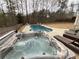 Sparkling hot tub and kidney shaped in-ground pool with a landscaped backyard at 8340 Nolandwood Ln, Villa Rica, GA 30180