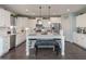 Bright kitchen featuring white cabinets, stainless steel appliances, pendant lighting and a large center island at 8340 Nolandwood Ln, Villa Rica, GA 30180