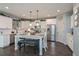 Bright kitchen featuring white cabinets, stainless steel appliances, pendant lighting and a large center island at 8340 Nolandwood Ln, Villa Rica, GA 30180