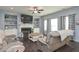 Spacious living room with a fireplace, built-in shelves and dark stained hardwood floors at 8340 Nolandwood Ln, Villa Rica, GA 30180