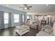 Open living room with hardwood floors, neutral colors and checkered pattern curtains at 8340 Nolandwood Ln, Villa Rica, GA 30180
