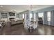 Bright and airy living room with an open floorplan and access to the dining area at 8340 Nolandwood Ln, Villa Rica, GA 30180