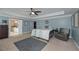 Spacious main bedroom with neutral carpet, a tray ceiling, ceiling fan, and seating area at 8340 Nolandwood Ln, Villa Rica, GA 30180