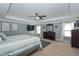 Spacious main bedroom with a tray ceiling, ceiling fan, and ample natural light at 8340 Nolandwood Ln, Villa Rica, GA 30180
