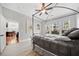 Sunlit bedroom featuring a canopy bed, light wood floors, and a view into the living spaces at 11 Perimeter E Ctr # 1115, Atlanta, GA 30346