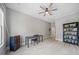 Bedroom with gray walls, light wood flooring, a desk, a bookcase, and a ceiling fan at 11 Perimeter E Ctr # 1115, Atlanta, GA 30346