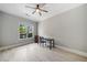 Bright bedroom features wood floors, large window and ceiling fan at 11 Perimeter E Ctr # 1115, Atlanta, GA 30346