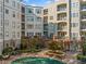 The courtyard of the condo features a covered pool, red brick, and multiple levels of condos with balconies and patios at 11 Perimeter E Ctr # 1115, Atlanta, GA 30346