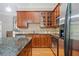 Well-equipped kitchen featuring stainless steel appliances, granite countertops, and wooden cabinets at 11 Perimeter E Ctr # 1115, Atlanta, GA 30346