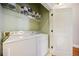 Laundry room equipped with a washer, a dryer, and a wire rack for storage at 11 Perimeter E Ctr # 1115, Atlanta, GA 30346