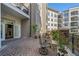 A charming brick patio with wrought iron seating and lush potted plants creates an inviting outdoor space at 11 Perimeter E Ctr # 1115, Atlanta, GA 30346