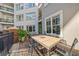 Inviting outdoor patio featuring a tile-top table, seating, and lush green plants at 11 Perimeter E Ctr # 1115, Atlanta, GA 30346