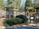 Inviting entrance to the community pool area with lush bushes and pergola covered seating at 1401 Riverview Se Dr # 1401, Marietta, GA 30067