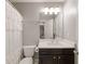 Cozy bathroom with ruffled shower curtain, dark vanity, and white countertop at 3930 Covey Flush Sw Ct # 21, Smyrna, GA 30082