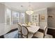 Elegant dining room featuring a crystal chandelier, wainscoting, and bay window at 3930 Covey Flush Sw Ct # 21, Smyrna, GA 30082