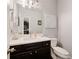 Stylish powder room with dark wood vanity, modern fixtures, and elegant decor, adding a touch of luxury to the space at 3930 Covey Flush Sw Ct # 21, Smyrna, GA 30082