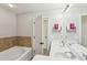 Bathroom showcasing a tub, tiled backsplash, and a double sink vanity at 5227 Whiteoak Se Ave, Smyrna, GA 30080