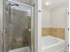 Bathroom featuring a separate shower and a soaking tub with tiled walls at 5227 Whiteoak Se Ave, Smyrna, GA 30080