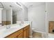 Well-lit bathroom with double sinks, wooden cabinetry, and tiled accents at 5227 Whiteoak Se Ave, Smyrna, GA 30080