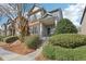 Inviting townhome featuring a covered front porch with swing, stone accents, and manicured landscaping at 5227 Whiteoak Se Ave, Smyrna, GA 30080