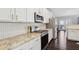 Modern kitchen featuring white cabinets, granite countertops, stainless appliances, and dark hardwood floors at 5227 Whiteoak Se Ave, Smyrna, GA 30080