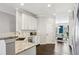 Well-lit kitchen with stainless appliances, granite countertops, and a view into the dining area at 5227 Whiteoak Se Ave, Smyrna, GA 30080