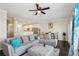 Spacious living area with a plush gray sectional, dark hardwood floors, and a view of the dining space at 5227 Whiteoak Se Ave, Smyrna, GA 30080