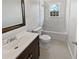 Classic bathroom featuring a tiled shower/tub combo, vintage style floor tiles, and a vanity with a sink at 6120 E Fayetteville Dr, Riverdale, GA 30296