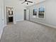 Carpeted bedroom with a ceiling fan, closet, and double windows at 6120 E Fayetteville Dr, Riverdale, GA 30296