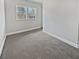 Light-filled carpeted bedroom with double windows at 6120 E Fayetteville Dr, Riverdale, GA 30296