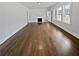 An empty living room boasts freshly painted walls, gleaming hardwood floors, and a charming fireplace at 6120 E Fayetteville Dr, Riverdale, GA 30296