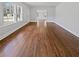 Bright living room boasts gleaming hardwood floors and natural light at 6120 E Fayetteville Dr, Riverdale, GA 30296