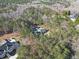 Aerial view of property showing the house, pool, and surrounding lush greenery at 9610 Cedar Grove Rd, Fairburn, GA 30213