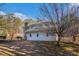 View of backyard, including gated pool area, trees, and grass at 9610 Cedar Grove Rd, Fairburn, GA 30213