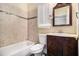 Classic bathroom featuring a tiled shower-tub, toilet, and vanity with storage at 9610 Cedar Grove Rd, Fairburn, GA 30213