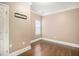 Well-lit bedroom featuring hardwood floors, white trim, and a closet at 9610 Cedar Grove Rd, Fairburn, GA 30213