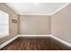 Bedroom featuring hardwood floors, white trim, and neutral paint at 9610 Cedar Grove Rd, Fairburn, GA 30213