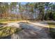 Circular driveway leads up to a luxury estate surrounded by mature trees in a private setting at 9610 Cedar Grove Rd, Fairburn, GA 30213