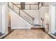 Grand foyer with a beautiful staircase, marble tile flooring, and abundant natural light at 9610 Cedar Grove Rd, Fairburn, GA 30213