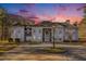 Elegant home with circular driveway, blue facade, and meticulous landscaping at 9610 Cedar Grove Rd, Fairburn, GA 30213