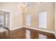 Bright living room boasting hardwood floors, large windows, and a stylish chandelier at 9610 Cedar Grove Rd, Fairburn, GA 30213