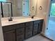 Bathroom featuring a dual sink vanity and a large mirror next to the shower at 115 Laurel Farms Ln, Dallas, GA 30157